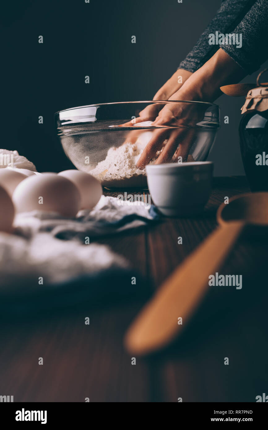 Premium Photo  Cooking close-up. white table with baking tools. cookie  molds and baking molds. women's hands knead the dough in a bowl. the  concept of culinary activity and meal.
