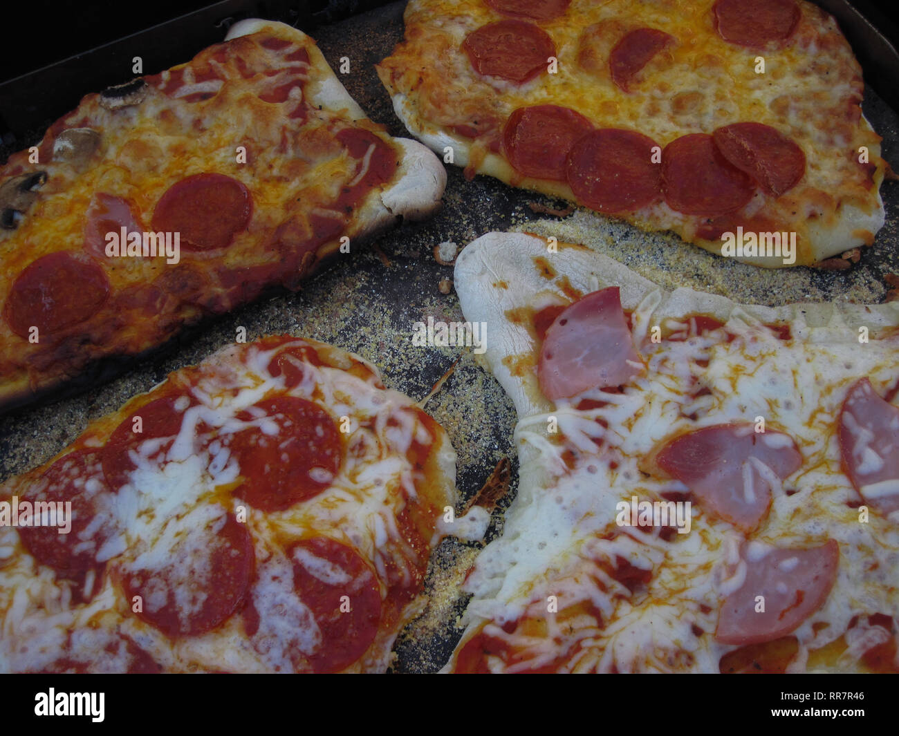 A close up view of a hand made pizza cooked on a bbq. Stock Photo