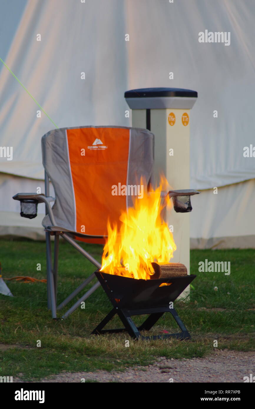 Campfire and Chair by a Large Traditional Tent on a Summer's Evening