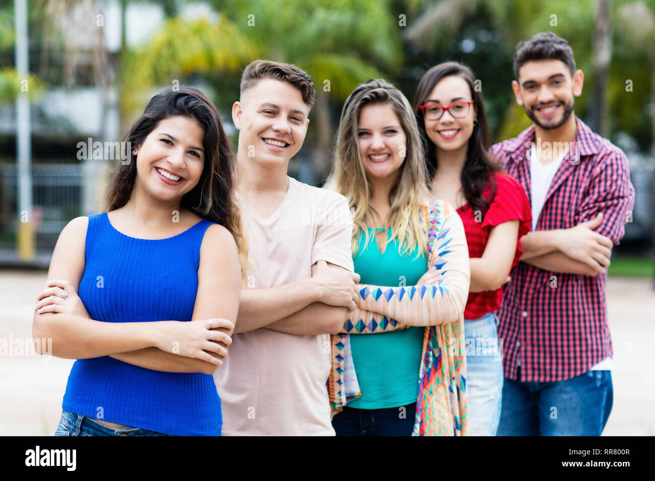 Spanish girl with male and female young adults in line outdoor in the city Stock Photo