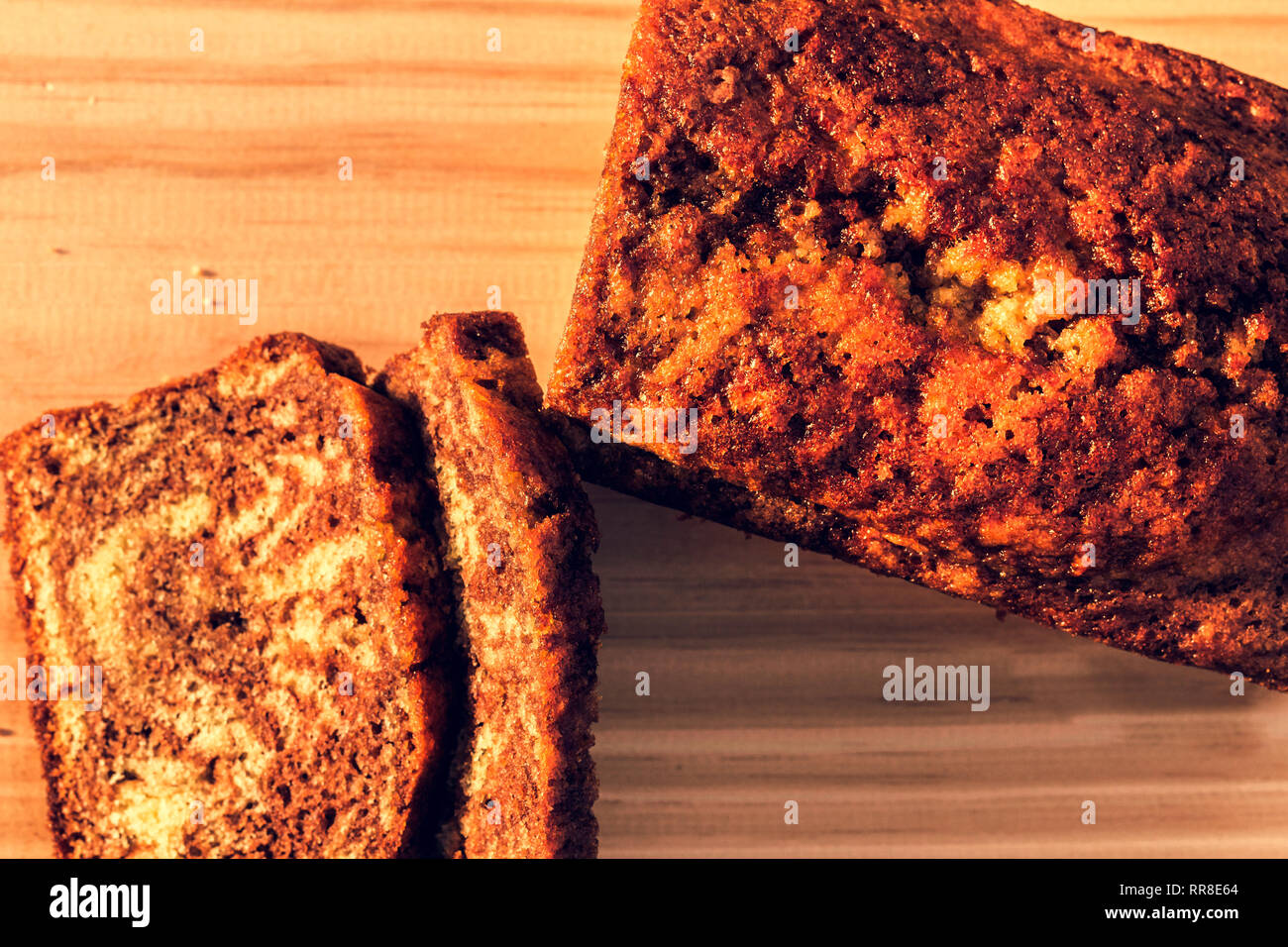 Chocolate sponge cake over light brown table, wood  background.Top view with copy space Stock Photo