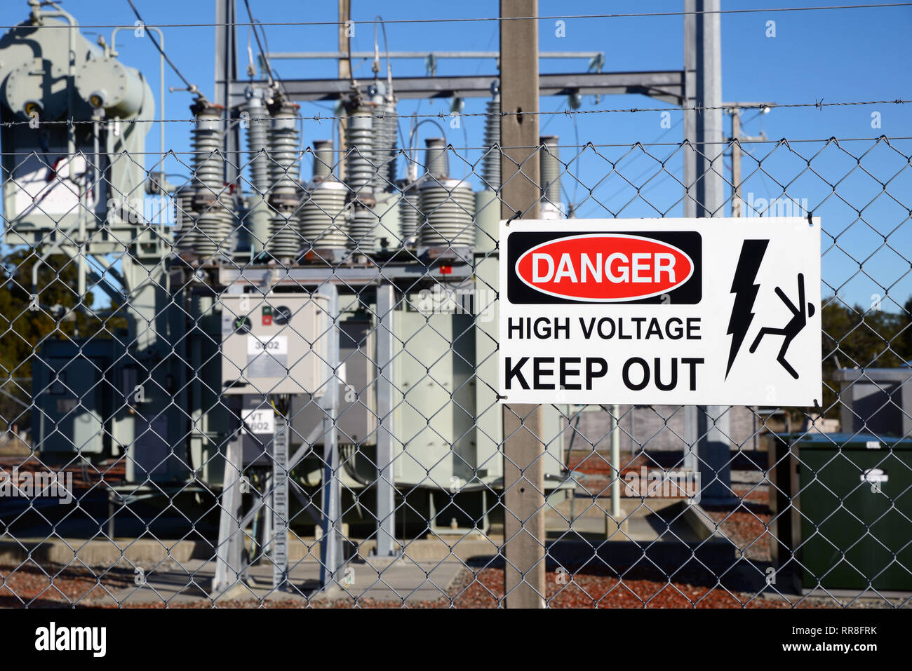 Signage warns people against accessing an electrical sub-station Stock Photo