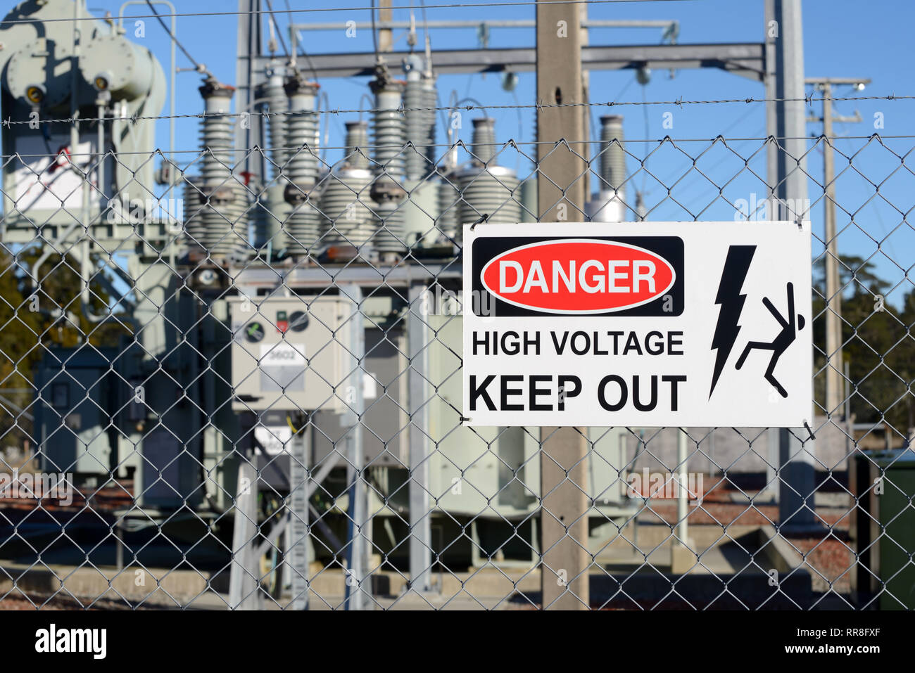 Signage warns people against accessing an electrical sub-station Stock Photo