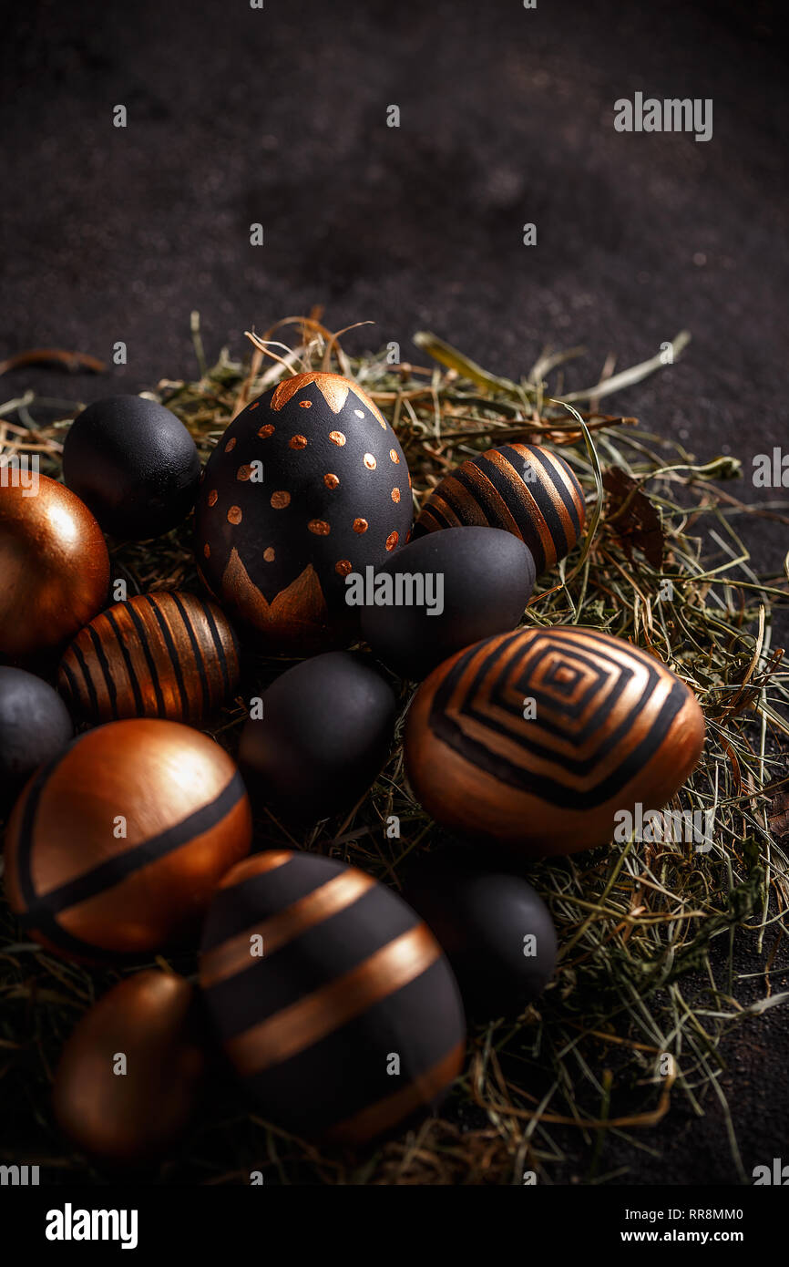 Easter composition with gold and black eggs in nest Stock Photo