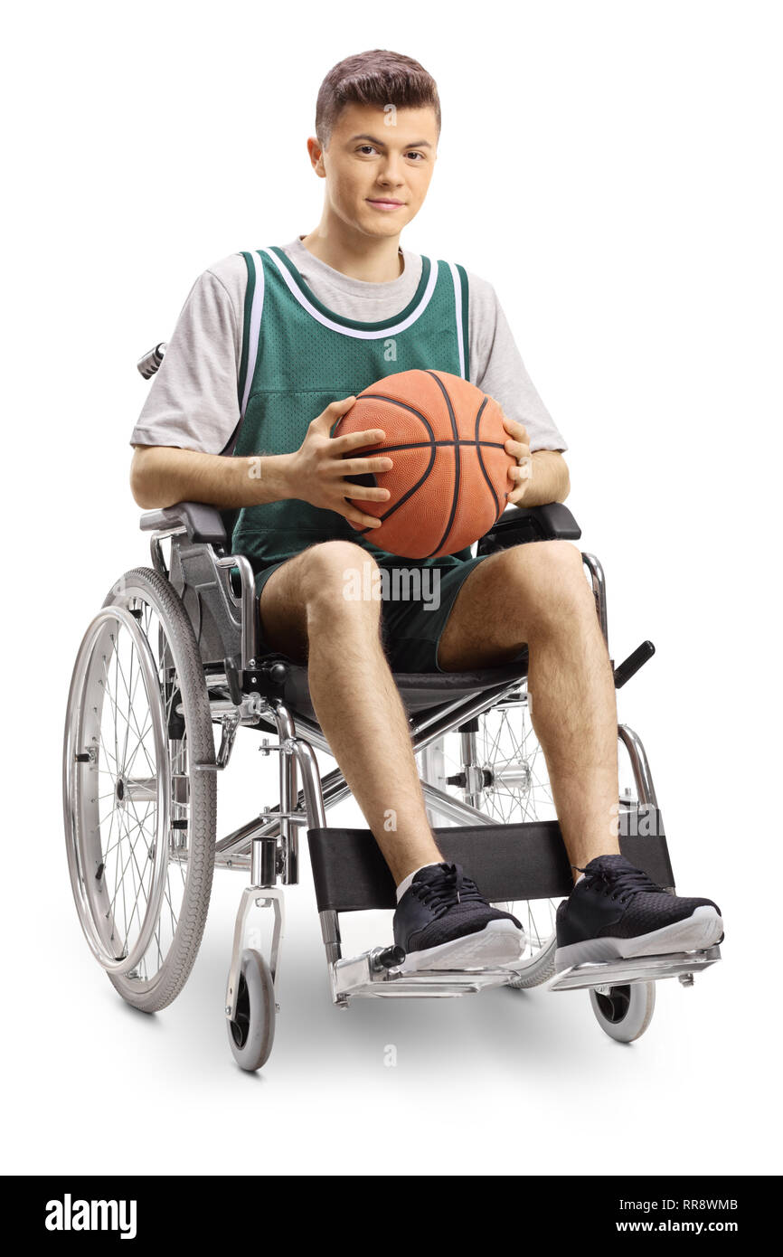 Full length portrait of a young man in a wheelchair holding a basketball and smiling at the camera isolated on white background Stock Photo
