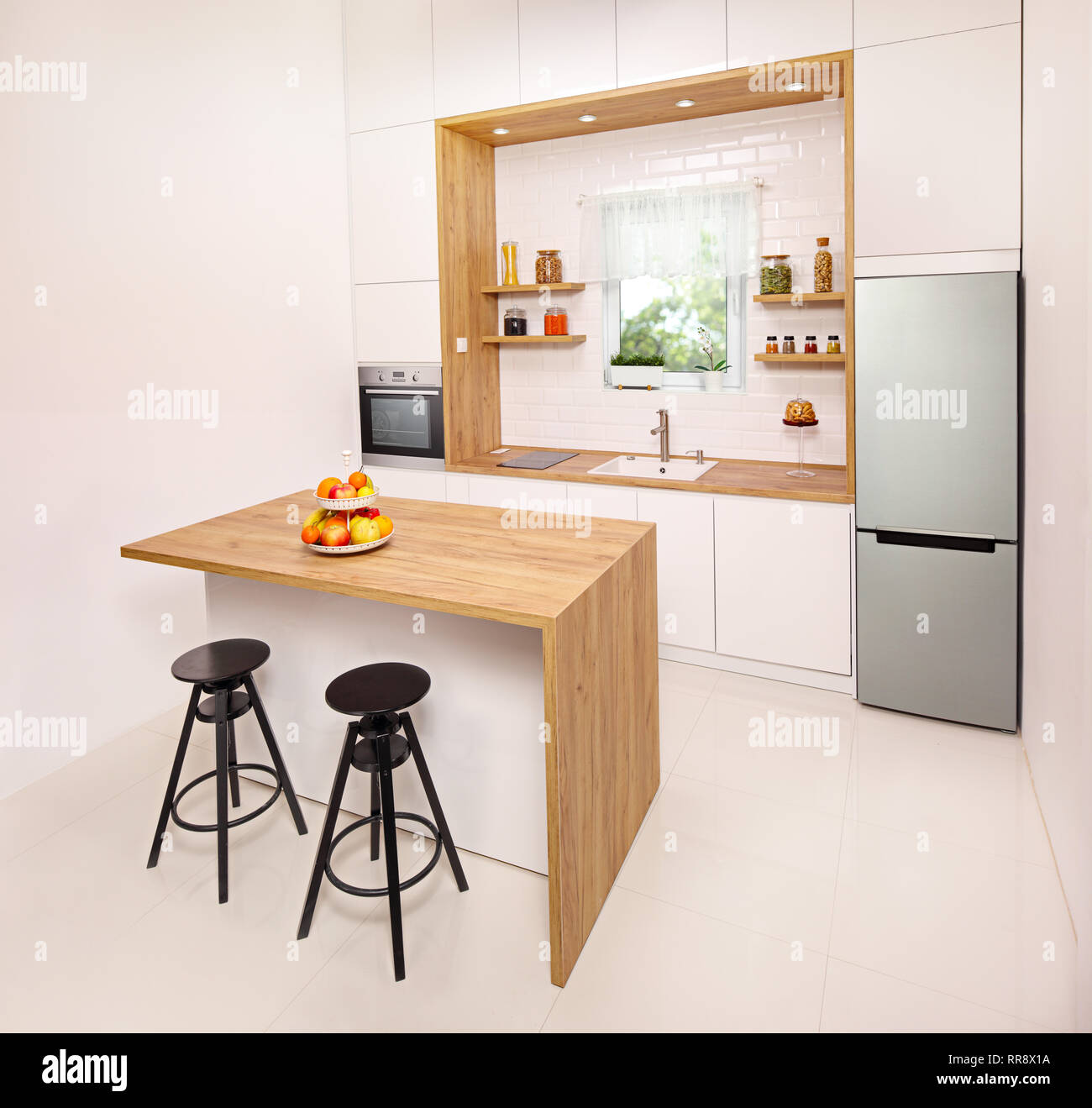 Kitchen interior with a window, island and bar stools Stock Photo - Alamy