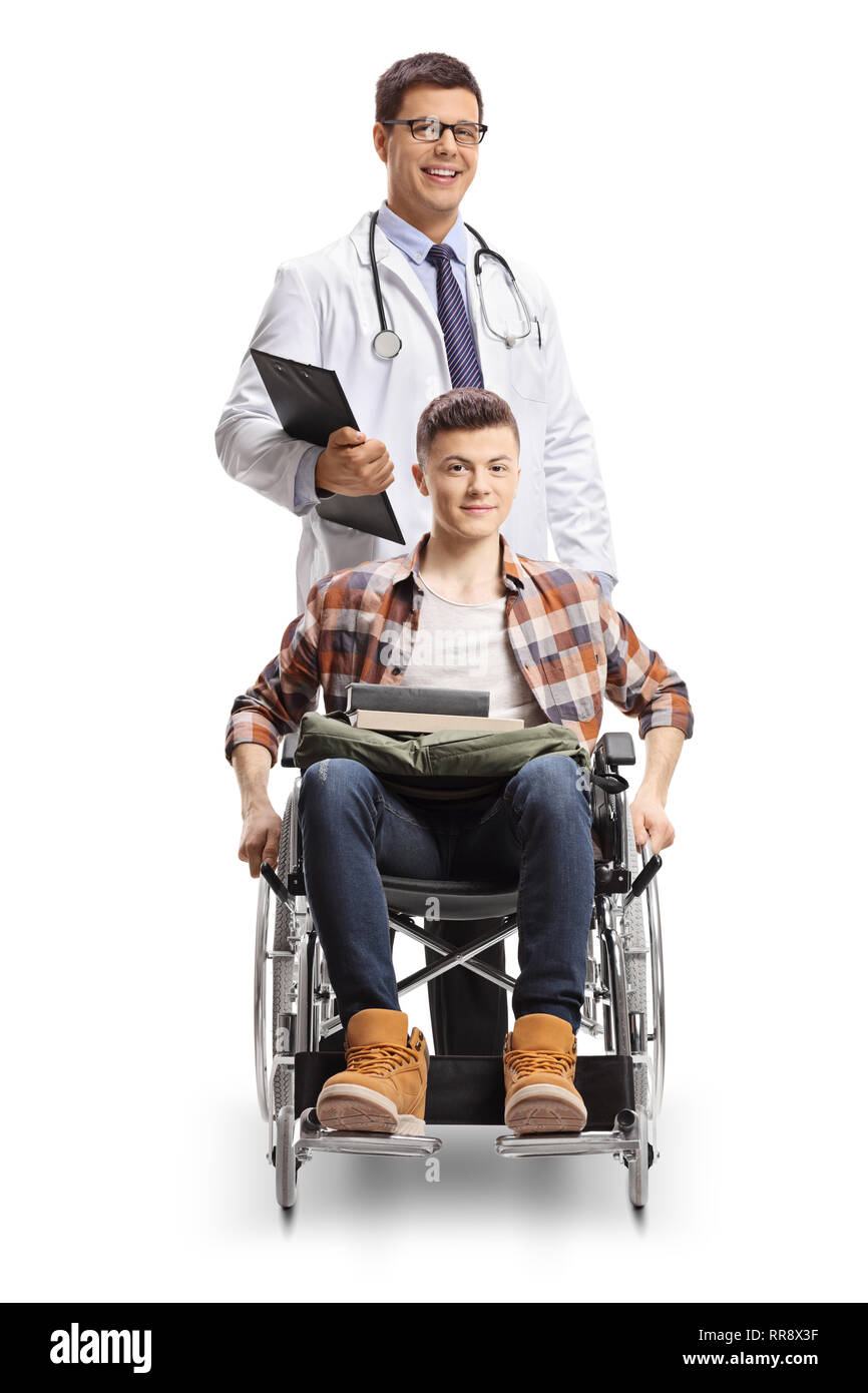 Young disabled male in a wheelchair and a doctor standing behind him isolated on white background Stock Photo