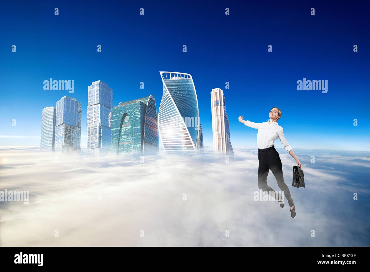 Businesswoman in formal wear flying in blue sky. Stock Photo