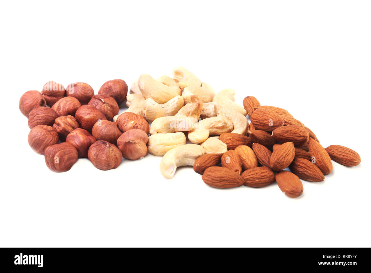 Mixed nuts from hazelnuts, almonds, cashews isolated on white background. Selective focus. Stock Photo