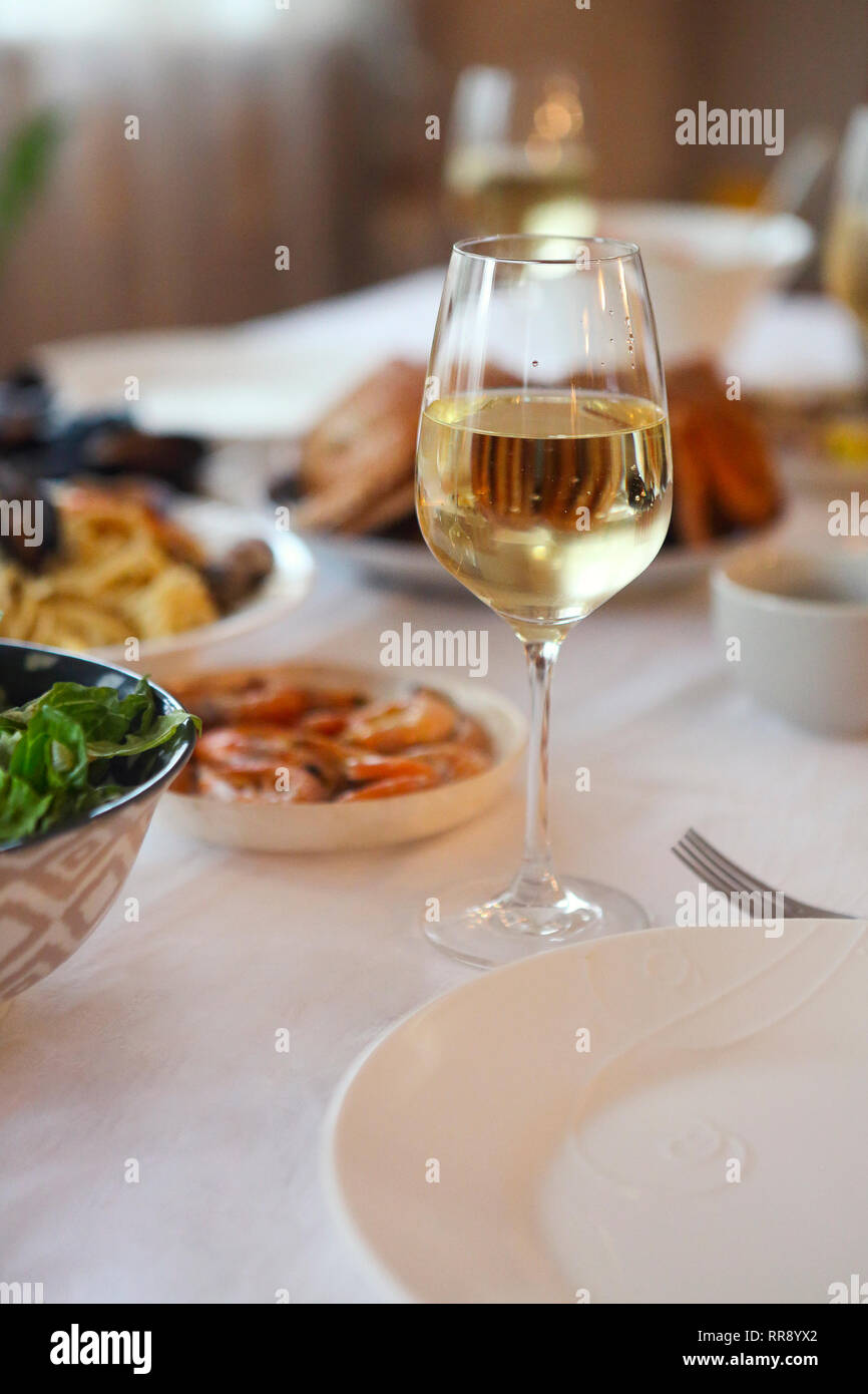 People fine dining seafood and white wine on the table Stock Photo