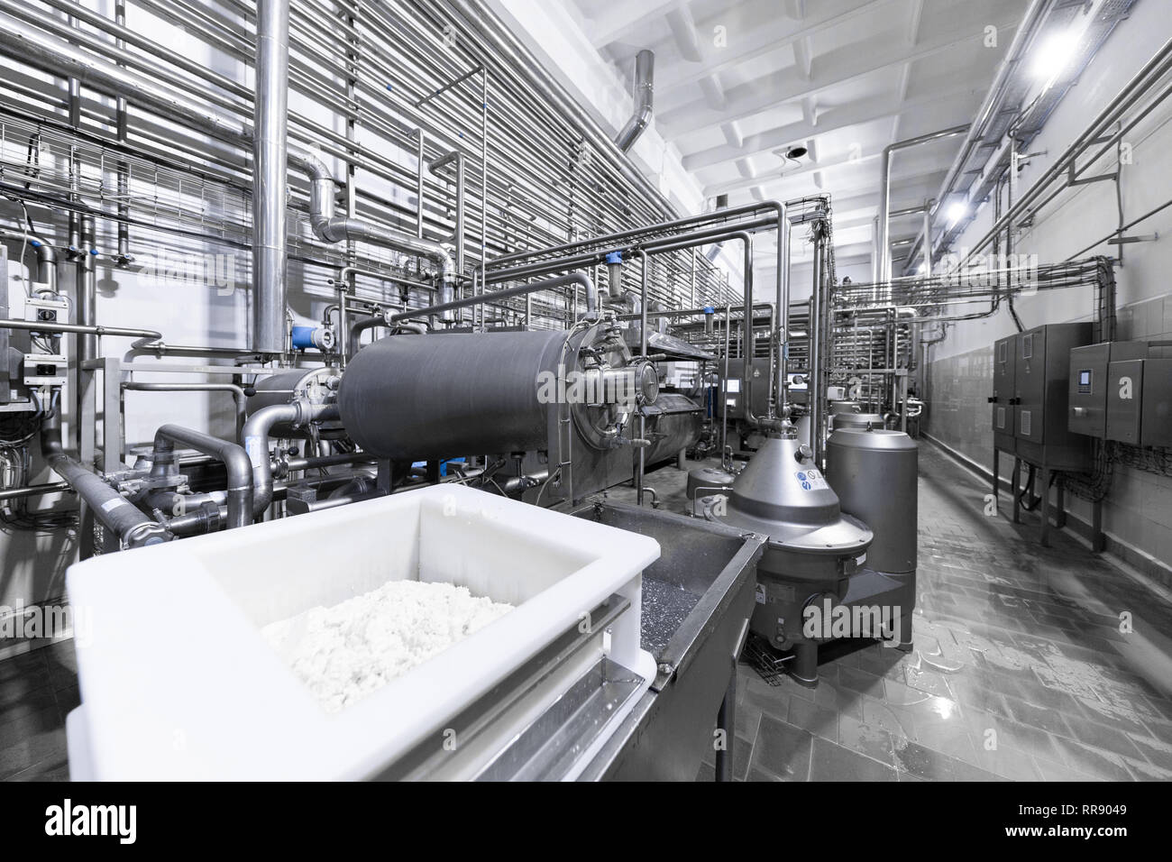 Steel Tanks And A White Container Of Cottage Cheese Industrial