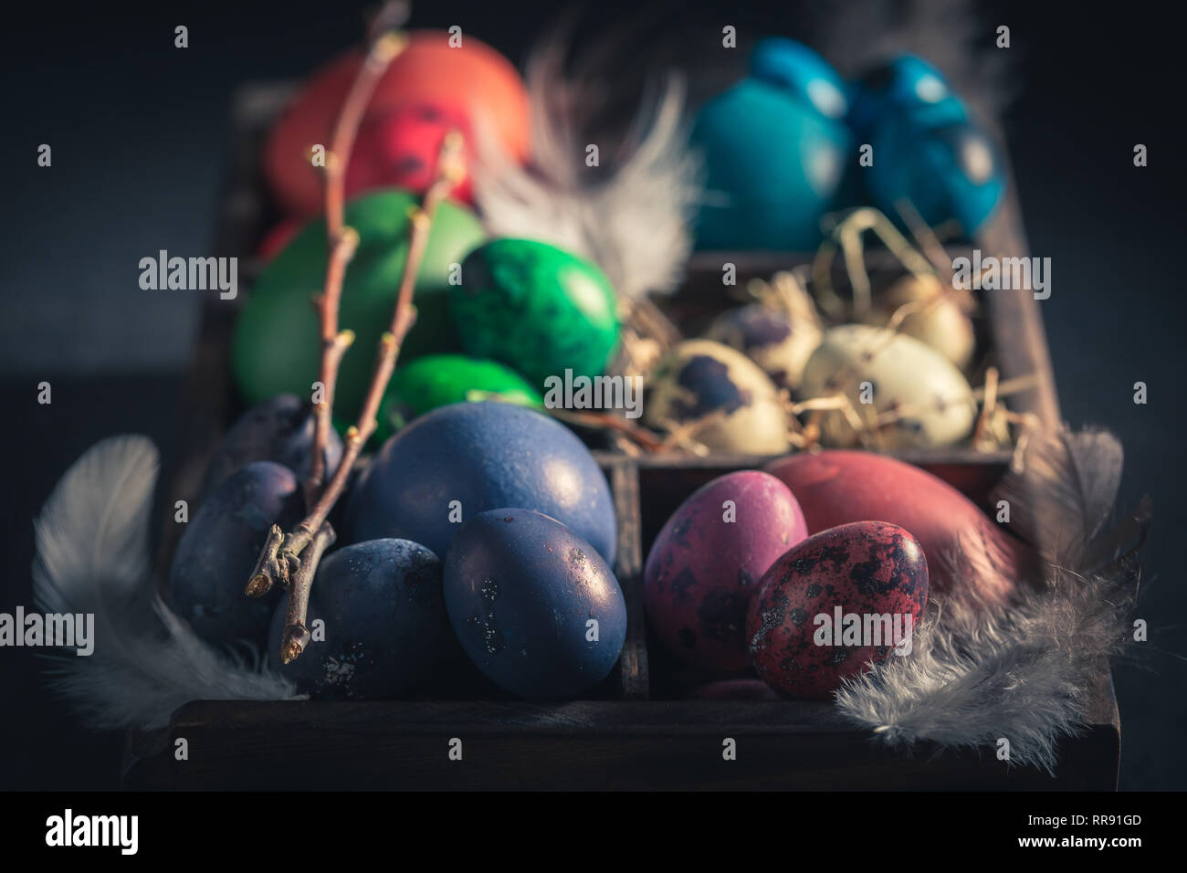 Various Easter eggs in small wooden box Stock Photo