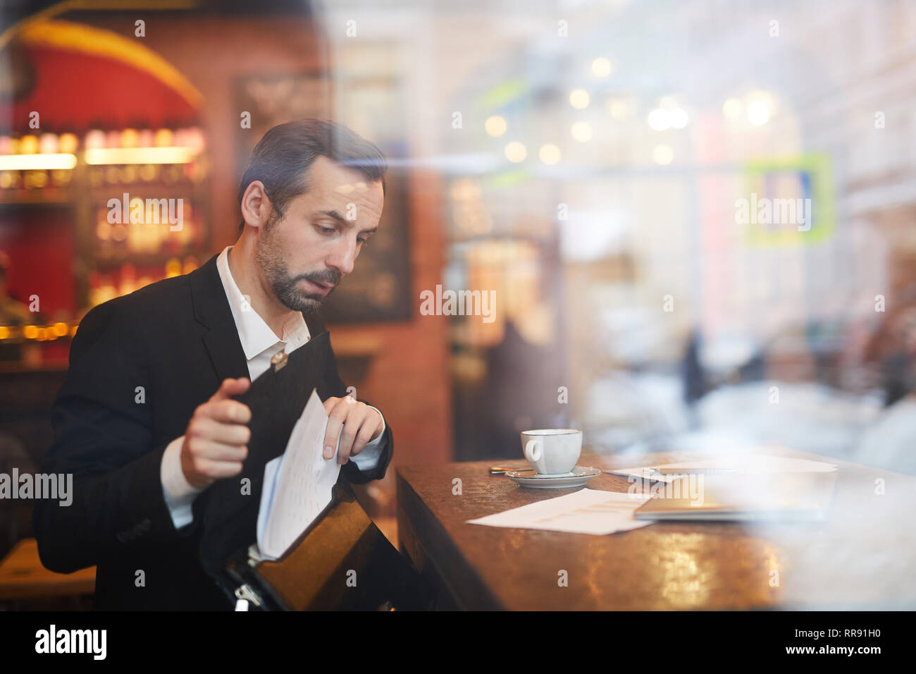 Businessman leaving Cafe Stock Photo