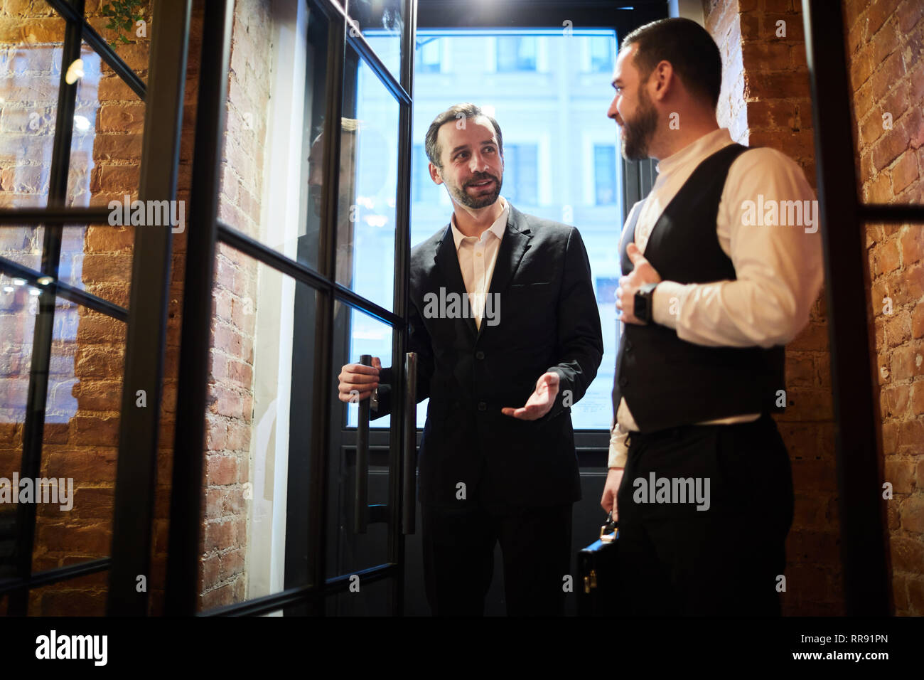 Gentlemen Entering Restaurant Stock Photo