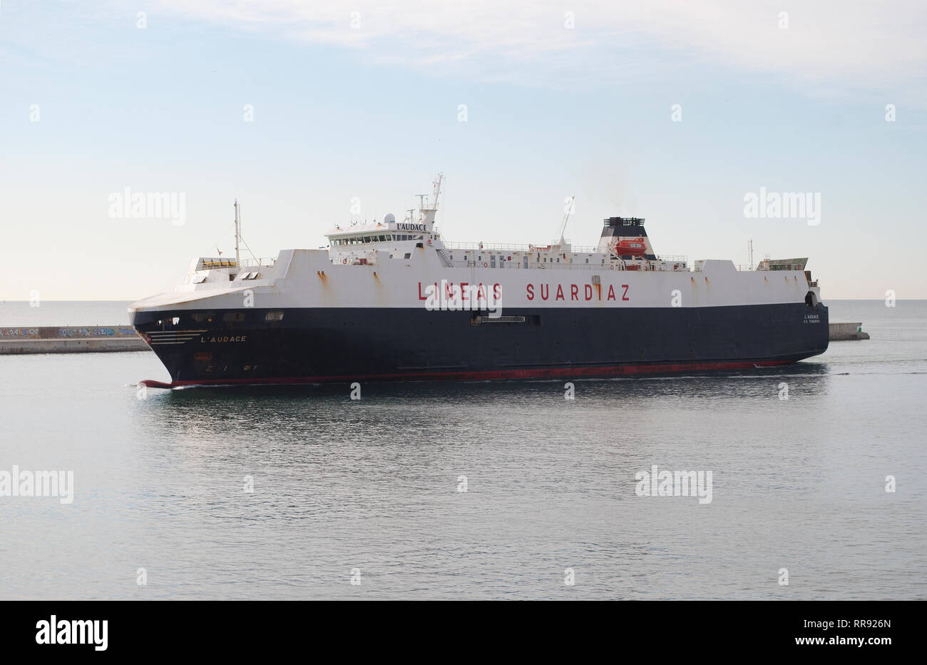 Merchant ship L'Audace entering the port of Barcelona. Stock Photo