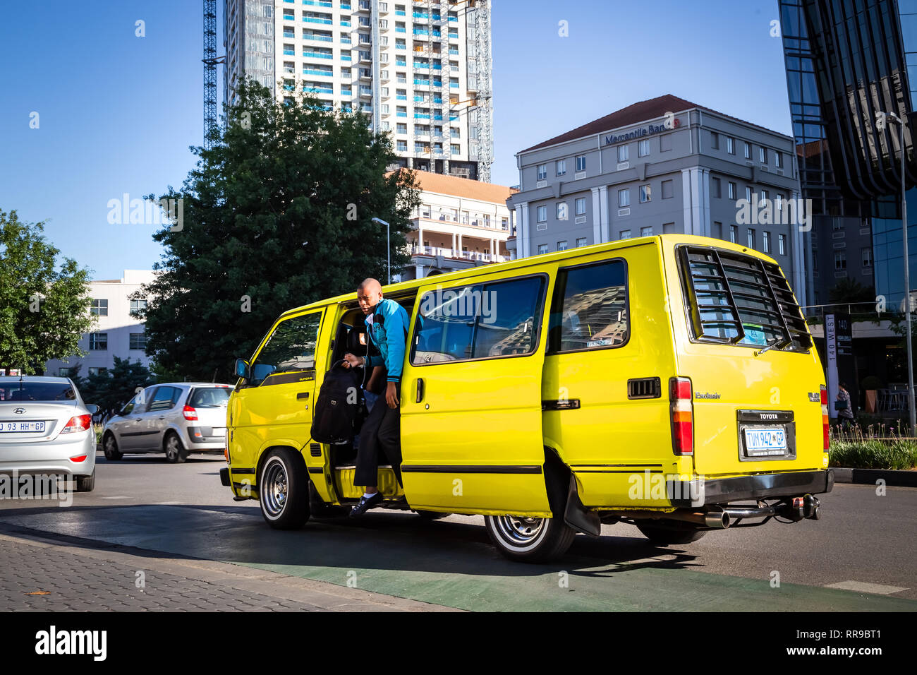 Johannesburg, South Africa, 28 November - 2018: Passenger getting out of mini bus taxi. Stock Photo