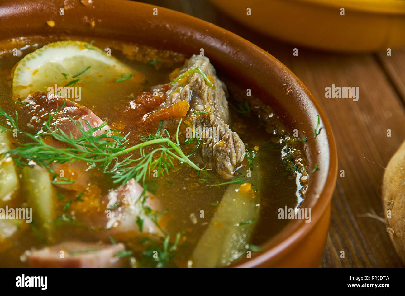 Solyanka, Russian traditional soups , assorted dishes, Top view.contain pickled cucumbers with brine, and often cabbage, salted mushrooms, potatoes, s Stock Photo