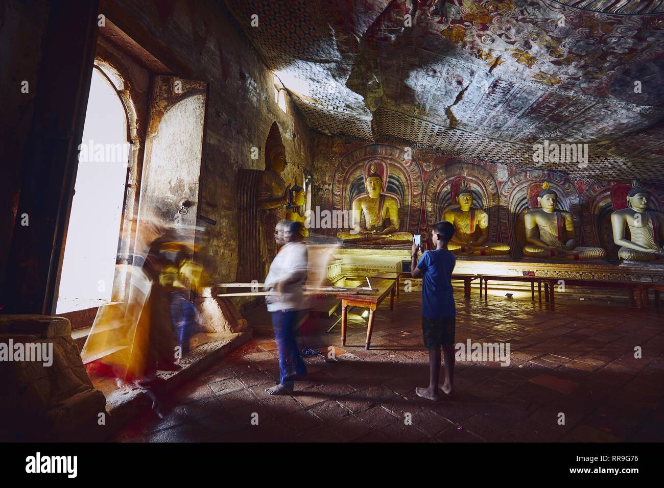 Dambulla, Sri Lanka - January 12, 2019: Statues and paintings inside  of largest and best preserved cave temple complex in Sri Lanka. Golden Temple of Stock Photo