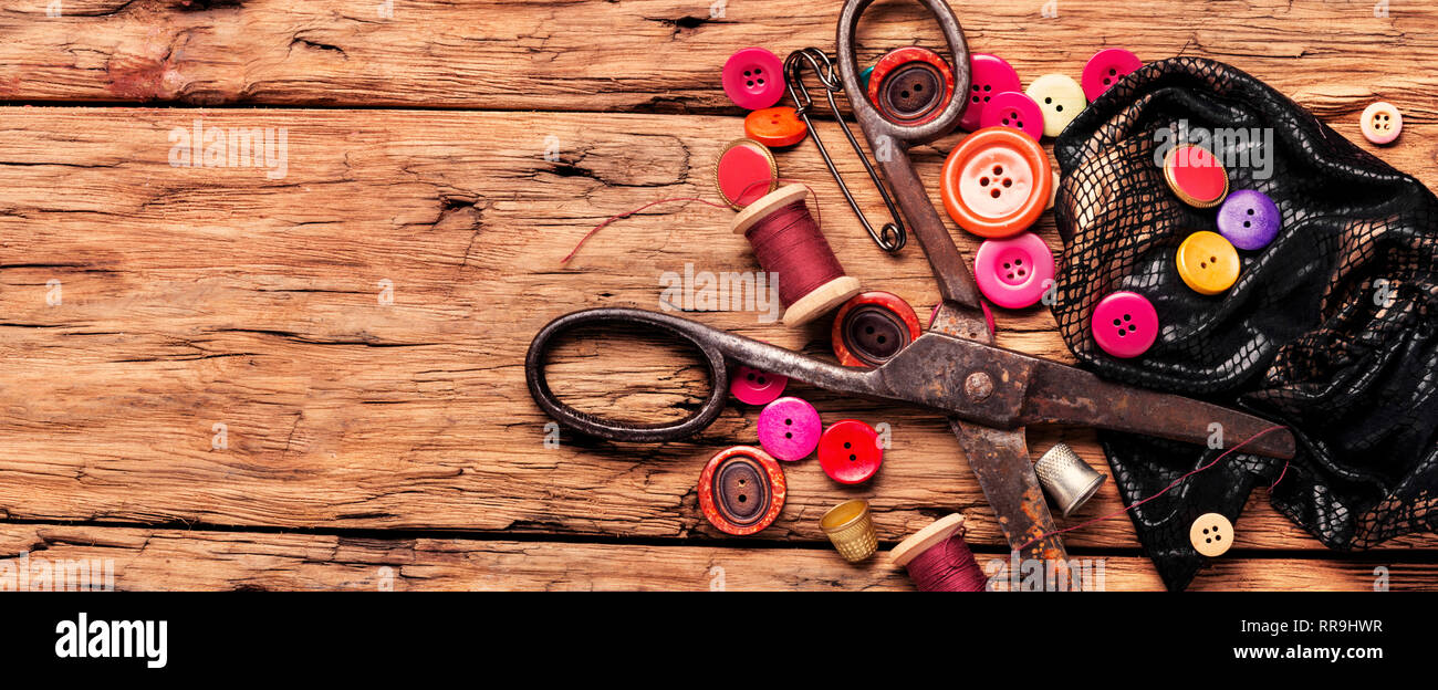 Spools of thread and basic sewing tools on wooden table.Sewing kit.Long banner Stock Photo