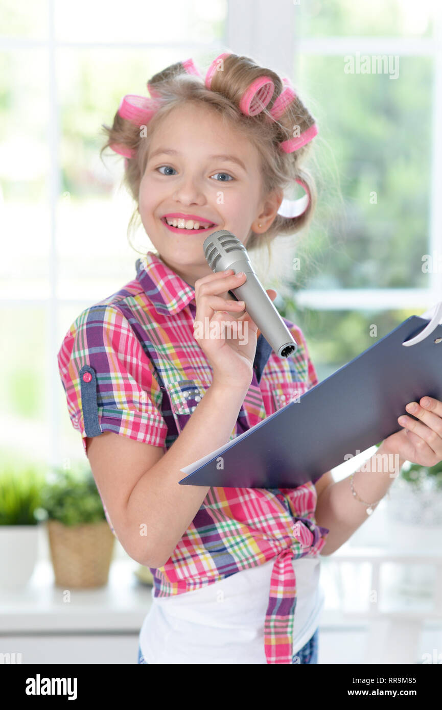 Portrait of adorable little girl singing karaoke Stock Photo Alamy