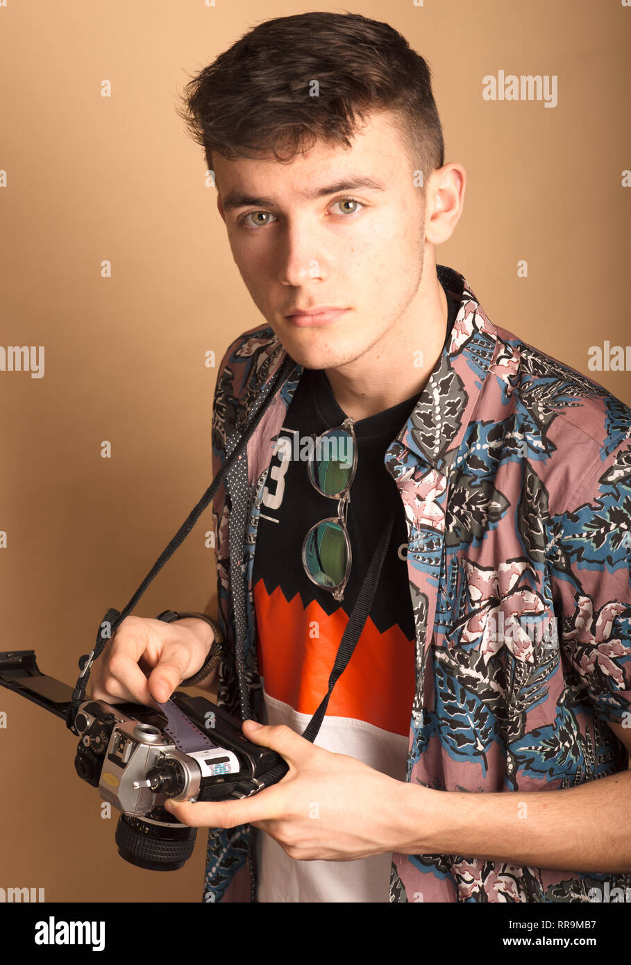 Photographer with an analogue SLR in a studio. Stock Photo
