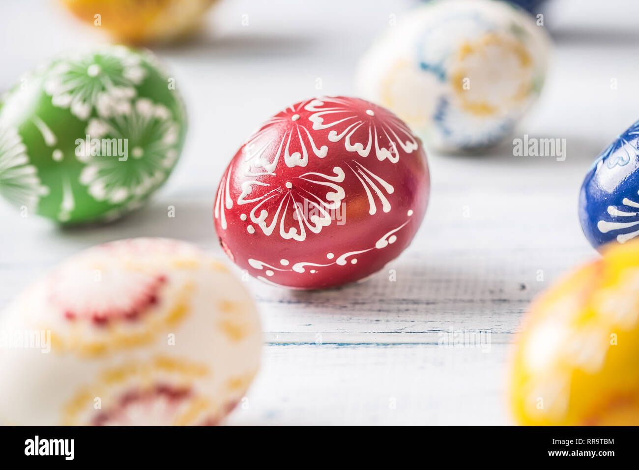 Close-up multicolored easter eggs on wooden table. Stock Photo