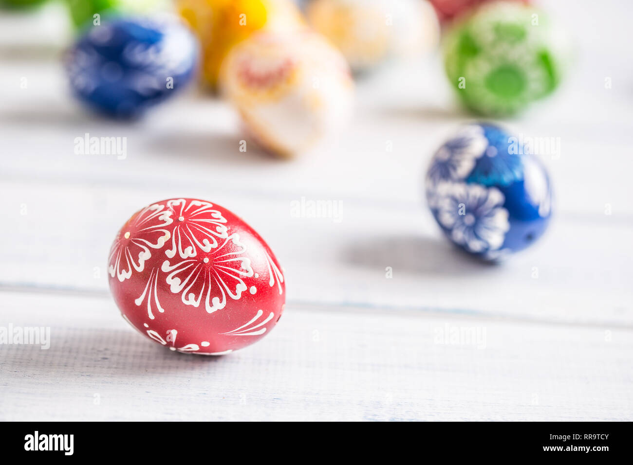 Close-up multicolored easter eggs on wooden table. Stock Photo