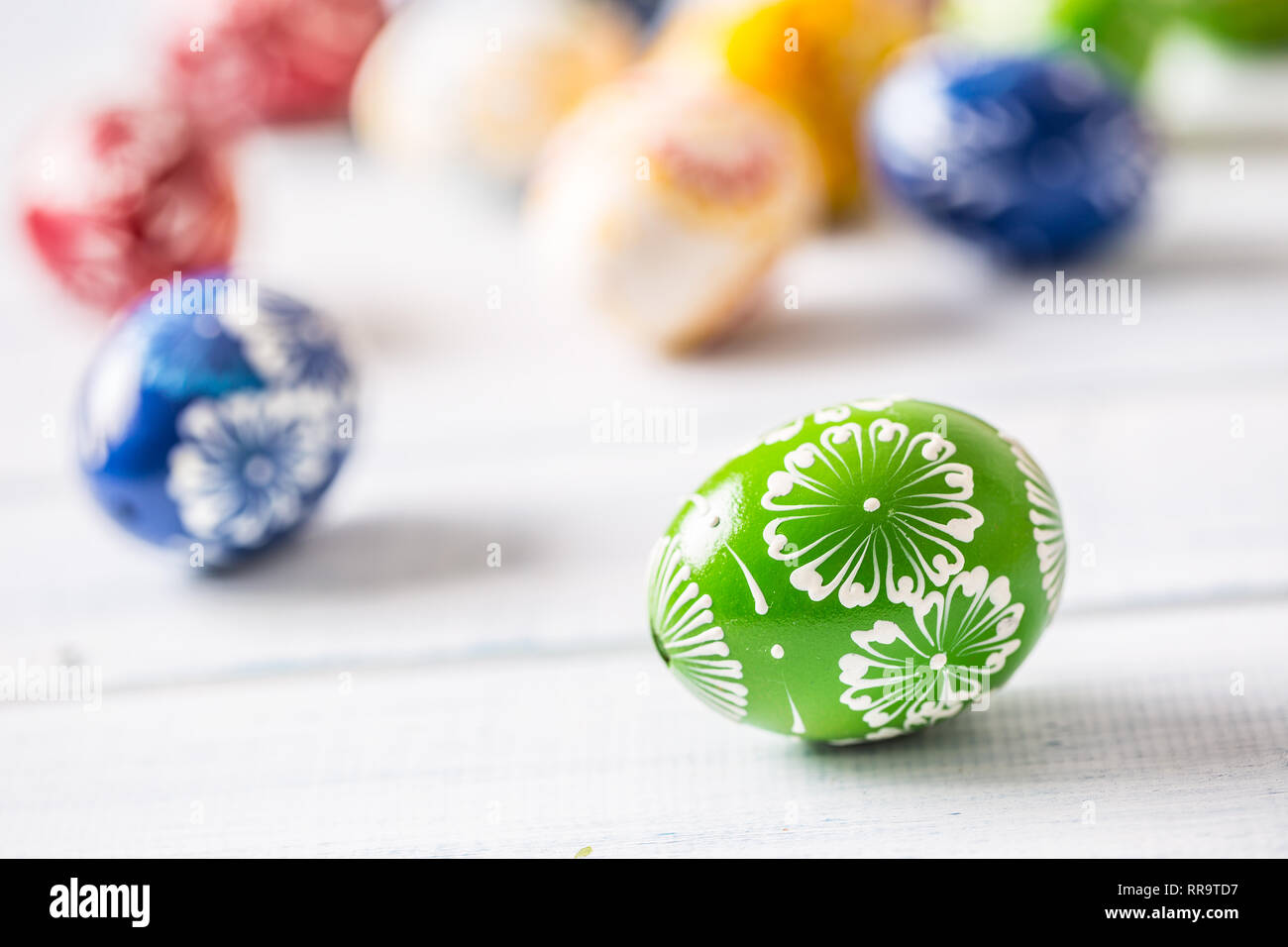 Close-up multicolored easter eggs on wooden table. Stock Photo