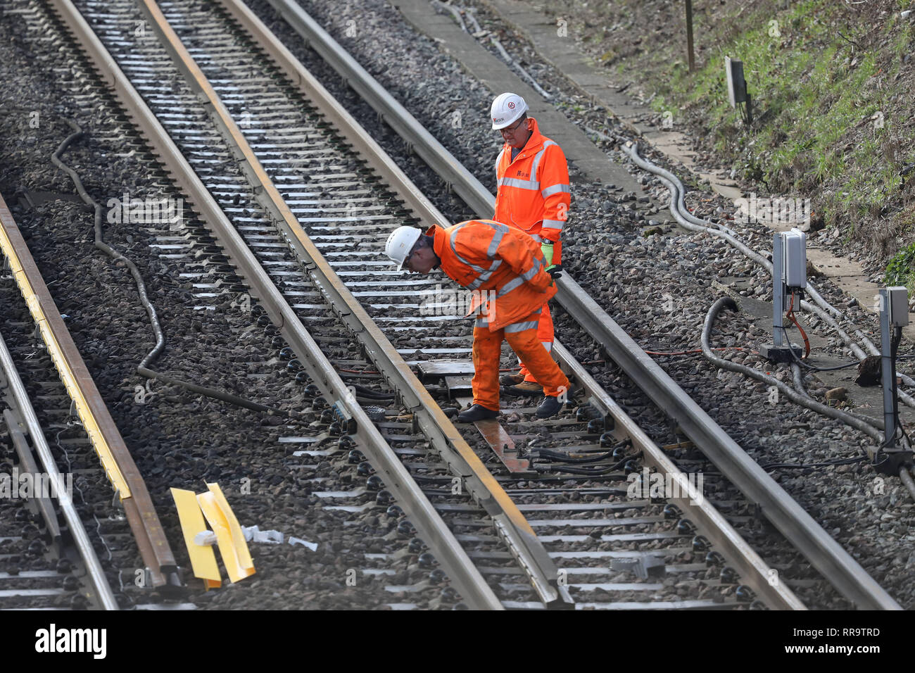 Railway engineers work on the track at the Southern end of the Brighton Main Line. The improvement works on the Brighton Main Line are a key part of a £300 million government-funded programme to tackle delay hotspots and boost the reliability of the railway in the south east, including the expanded Thameslink network. The Brighton Main Line is a key rail route, connecting Gatwick Airport and the south coast with London, and is used by 300,000 people each day. 20 February 2019 Stock Photo