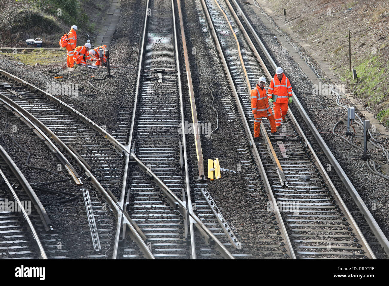 Railway engineers work on the track at the Southern end of the Brighton Main Line. The improvement works on the Brighton Main Line are a key part of a £300 million government-funded programme to tackle delay hotspots and boost the reliability of the railway in the south east, including the expanded Thameslink network. The Brighton Main Line is a key rail route, connecting Gatwick Airport and the south coast with London, and is used by 300,000 people each day. 20 February 2019 Stock Photo