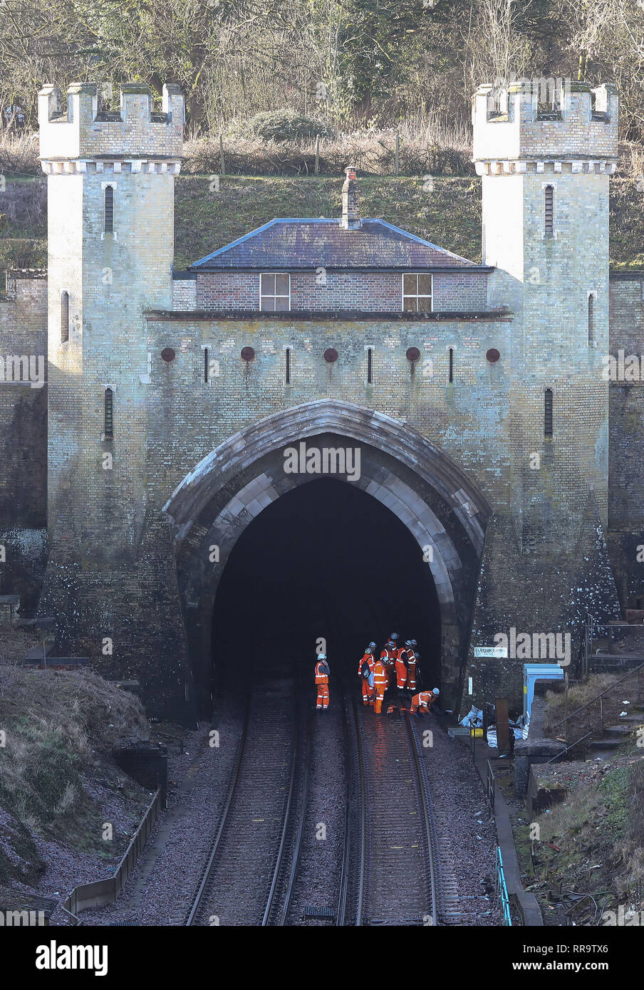 Network Rail engineers work on the track at North entrance to Clayton tunnel on the Brighton Main Line. The 1 mile 506 yard long tunnel is the longest tunnel on the line and was completed in 1841 The improvement works on the Brighton Main Line are a key part of a £300 million government-funded programme to tackle delay hotspots and boost the reliability of the railway in the south east, including the expanded Thameslink network. The Brighton Main Line is a key rail route, connecting Gatwick Airport and the south coast with London, and is used by 300,000 people each day. 20 February 2019 Stock Photo