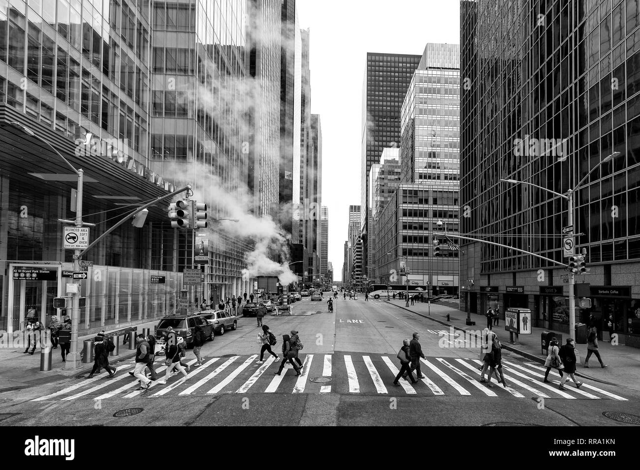 Shot of people crossing the road at 42 St and 6th Avenue, New York, taken from an open top bus. Stock Photo