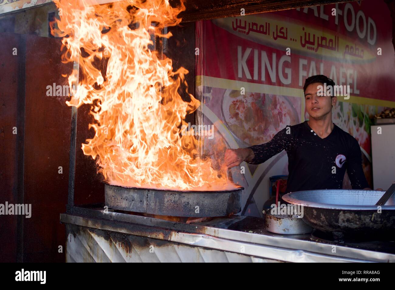 Flames bursting from a falafel deep frying pan Stock Photo