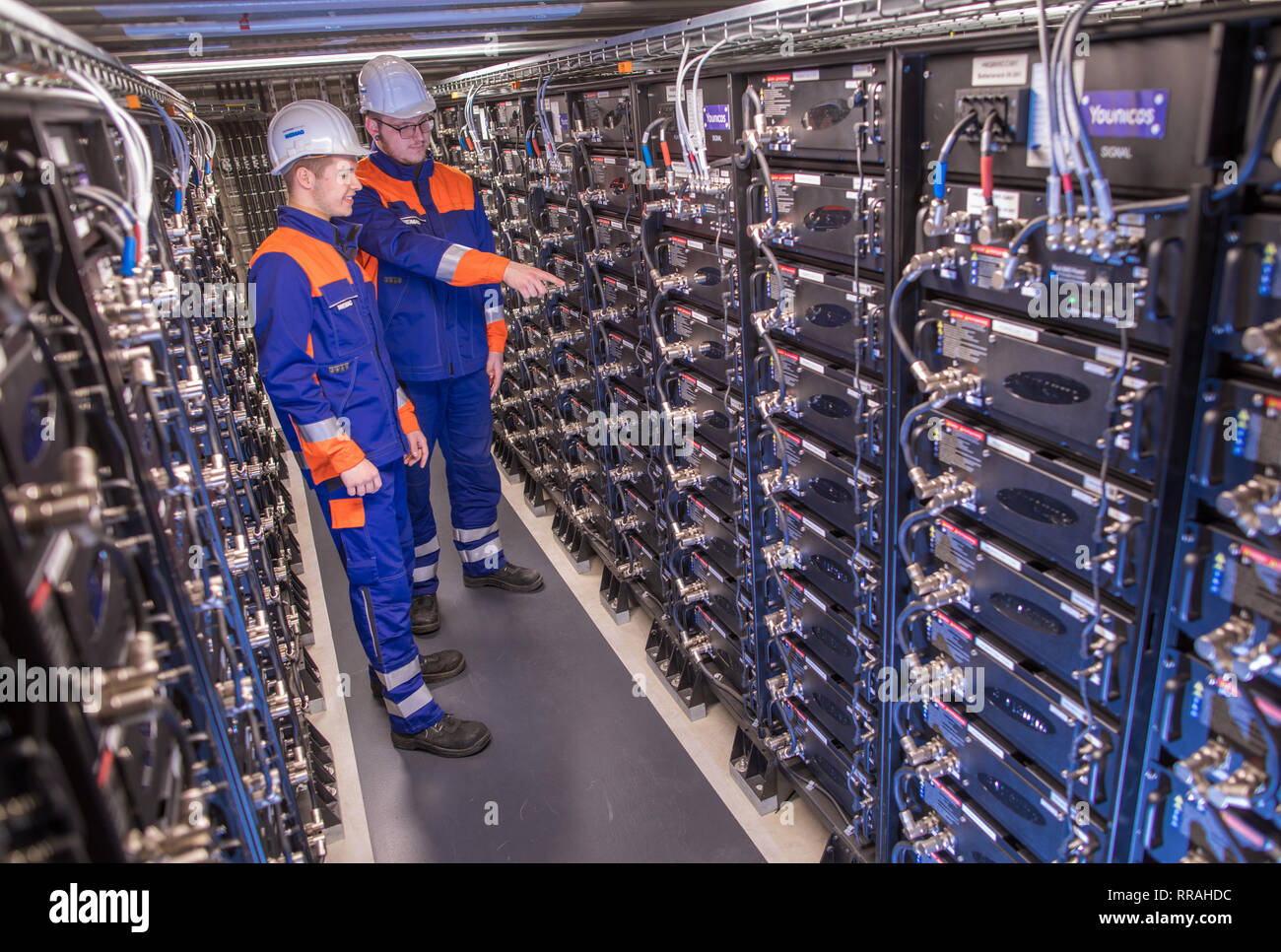 Schwerin, Germany. 25th Feb, 2019. The trainees Florian Maty (front) and Tom Hoffmann are standing in the battery storage of the energy supplier WEMAG. The skilled workers initiative 'Take off in MV' is launching a new campaign to improve the skilled workers situation in Mecklenburg-Western Pomerania. Credit: Jens Büttner/dpa-Zentralbild/ZB/dpa/Alamy Live News Stock Photo