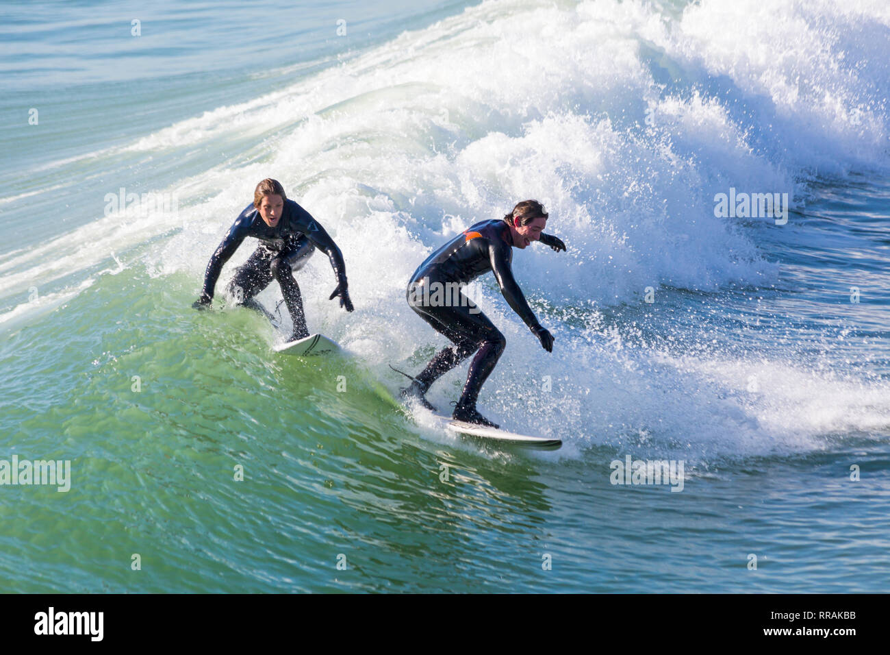 Bournemouth, Dorset, UK. 25th Feb, 2019. UK weather: big waves and plenty of surf create ideal surfing conditions for surfers at Bournemouth beach on a lovely warm sunny day expected to be the hottest day of the year and hottest February day ever.   Surfers on surf boards riding the waves. Credit: Carolyn Jenkins/Alamy Live News Stock Photo