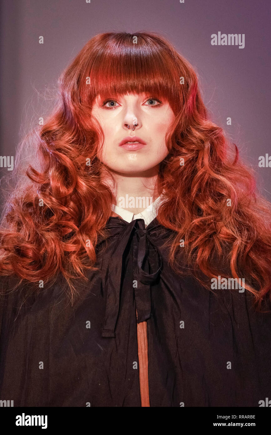 Excel, London, UK. 25th Feb, 2019. A model is styled by the styled by the  Headmasters Pro Artistic hairstyling team on the demo stage. The  Professional Beauty London show brings together hair