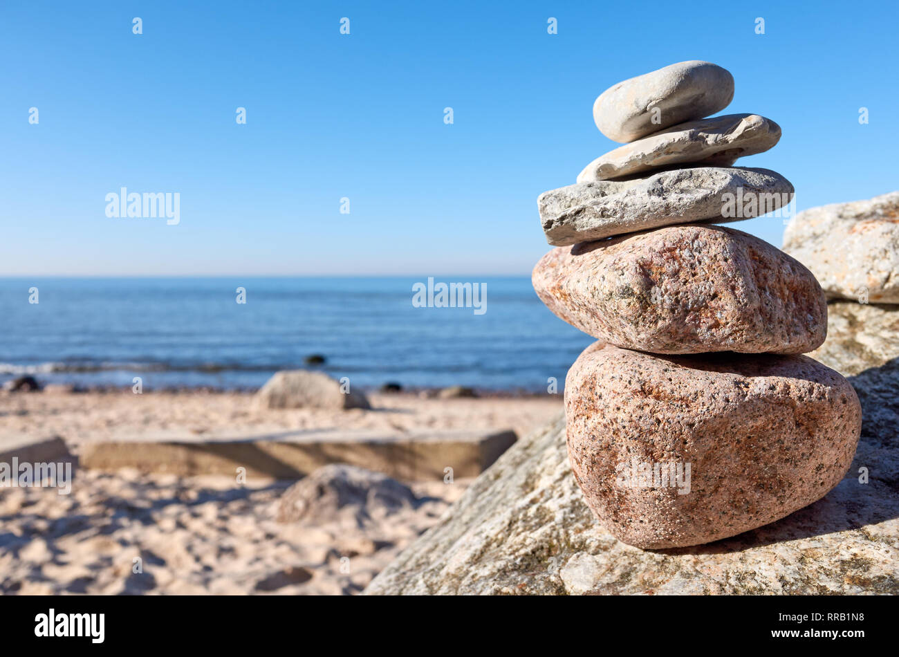 Stack of stones on a beach, balance and harmony concept, selective focus. Stock Photo