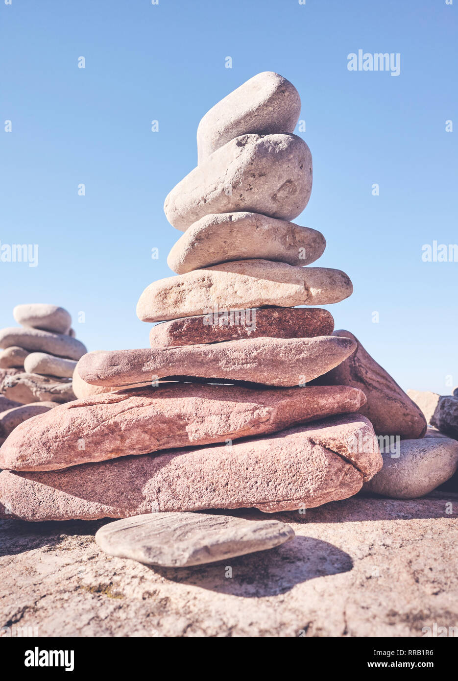 Stone pyramid, balance and harmony concept, selective focus, color toning applied. Stock Photo