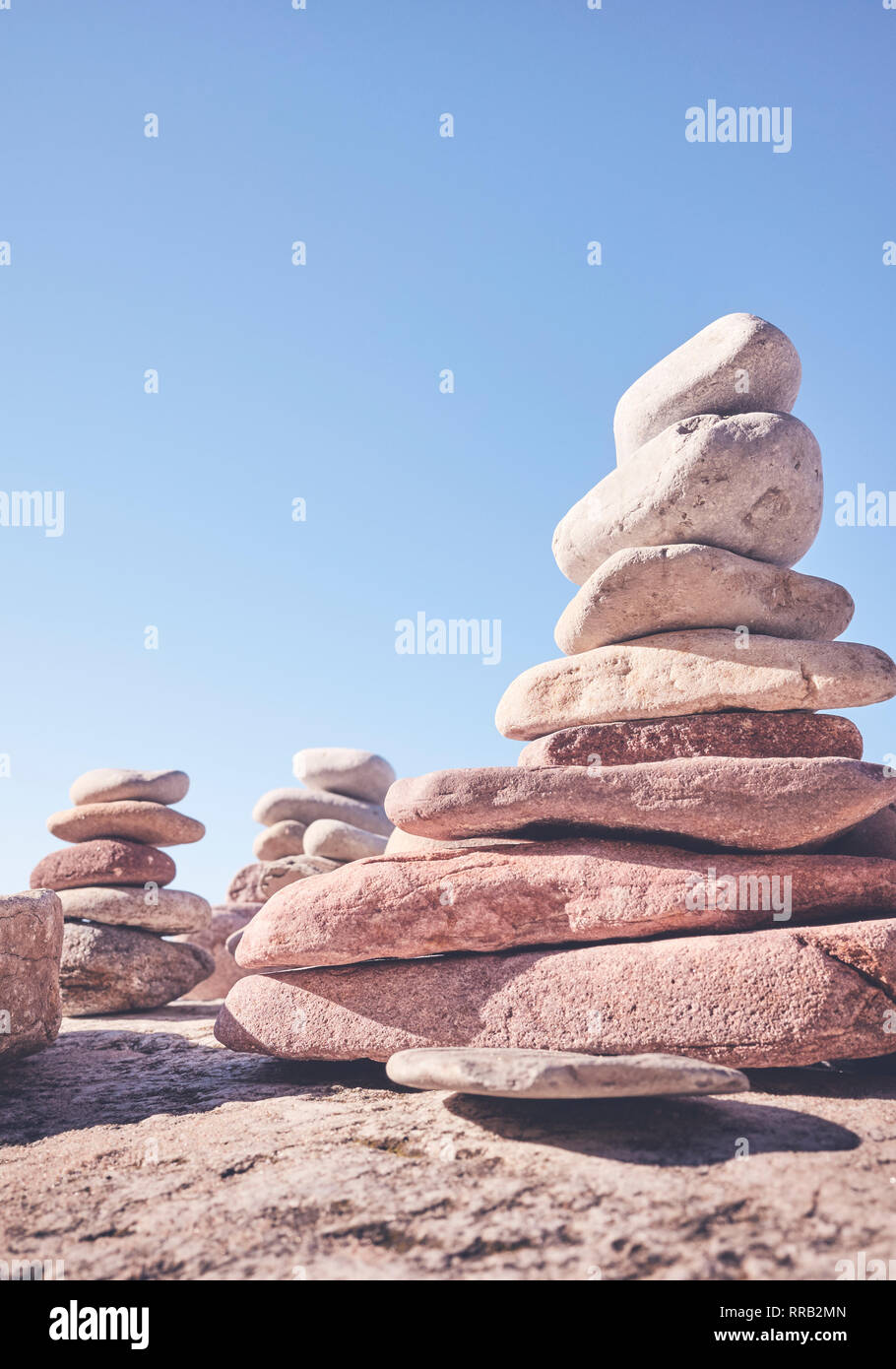 Stone pyramids, balance and harmony concept, selective focus, color toning applied. Stock Photo