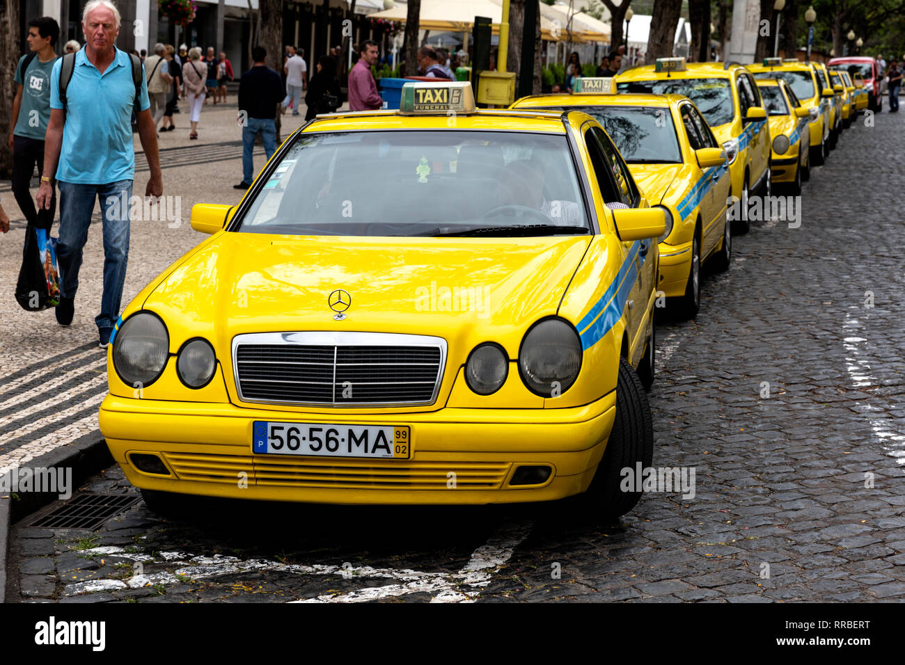 A line of yellow taxis for hire at the rank, Funchal, Madeira, Portugal. Stock Photo