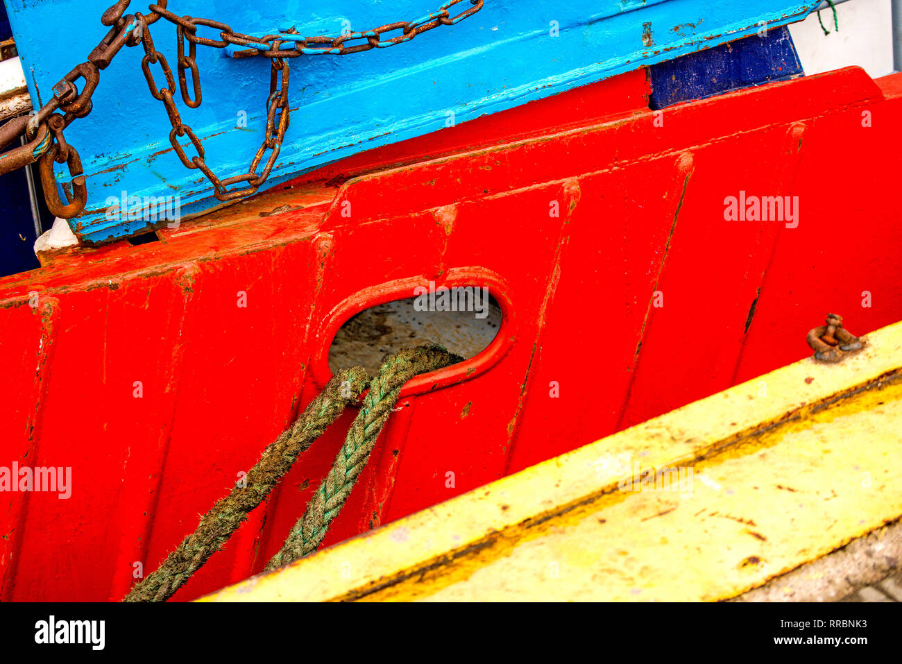 Mooring line of a trawler on a red ship hull Stock Photo Alamy