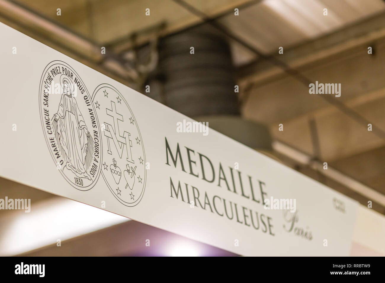 BOLOGNA, ITALY - FEBRUARY 18, 2019: lights are enlightening  MEDAILLE MIRACULEUSE logo on signboard on stand in DEVOTIO Religious products and service Stock Photo