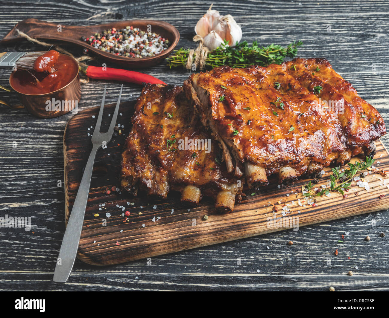 grilled pork ribs with sauce on a cutting board Stock Photo