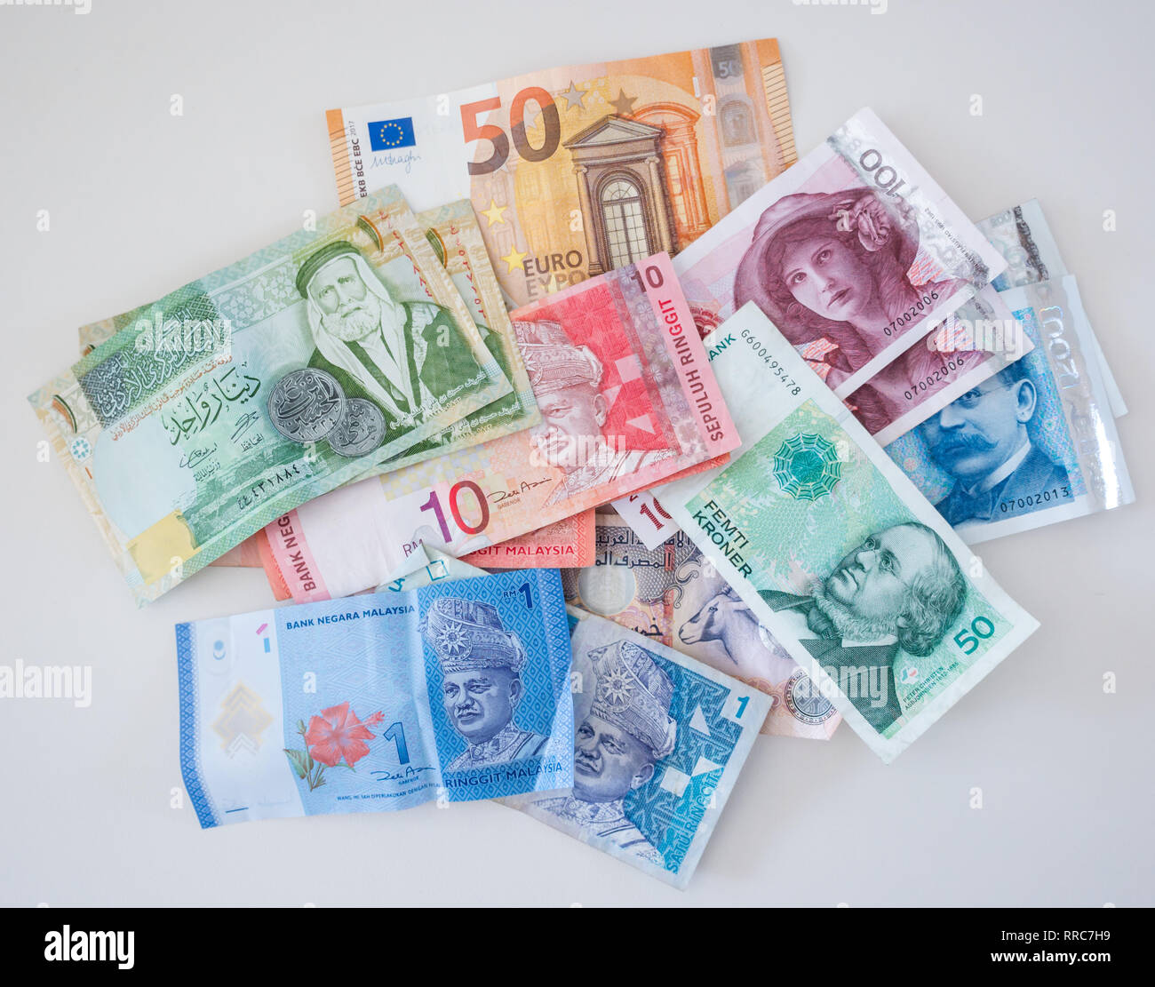 Foreign money banknotes; Fifty Euros, 200, 100 and 50 Norwegian Kroner, Malaysian 10 and 1 Ringgit, one Jordanian Dinar notes, UAE Dirham Stock Photo