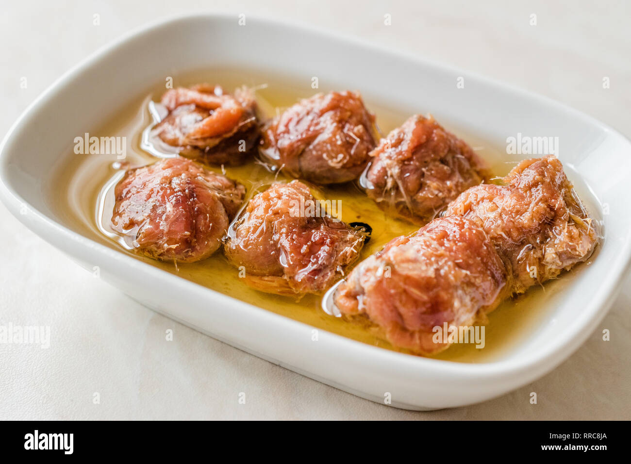 Marinated Canned Anchovy Fillet in Bowl / Anchovies served with Black Pepper on Marble Board. Organic Seafood Stock Photo