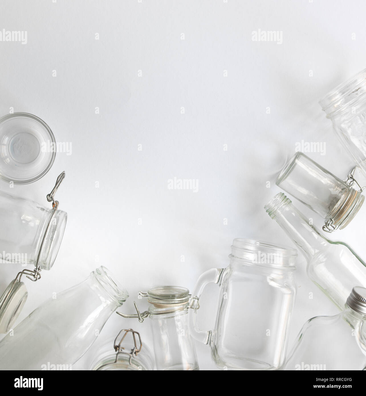 many different empty glass bottles lying on a white background Stock Photo