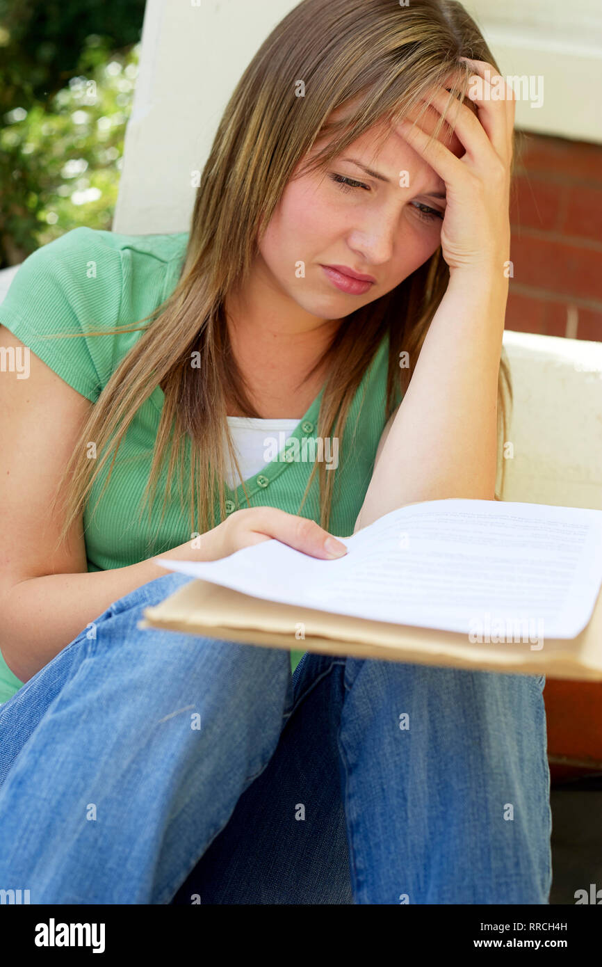 Upset girl failing her exams Stock Photo