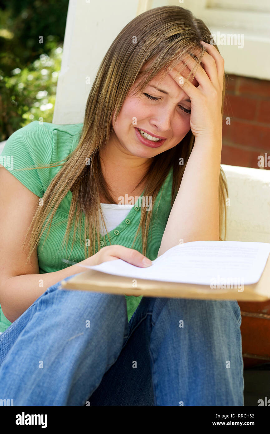 Upset girl failing her exams Stock Photo