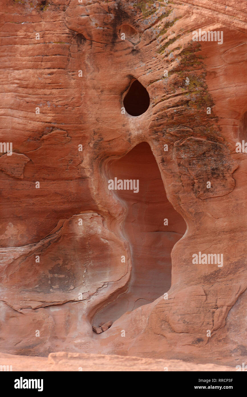 Eroded sandstone rock formations at Valley of Fire State Park, Nevada, USA. Burning candle-shaped cavity in the rock. Stock Photo
