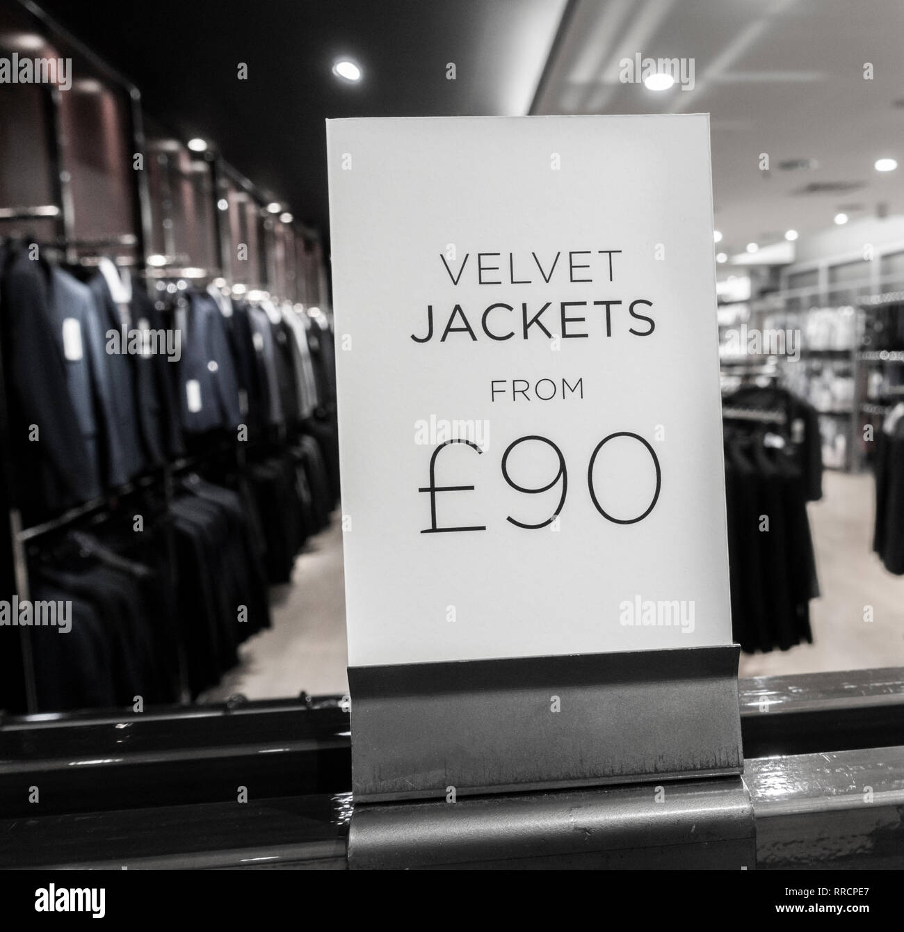 Velvet jacket price sign in Next clothing store. UK Stock Photo